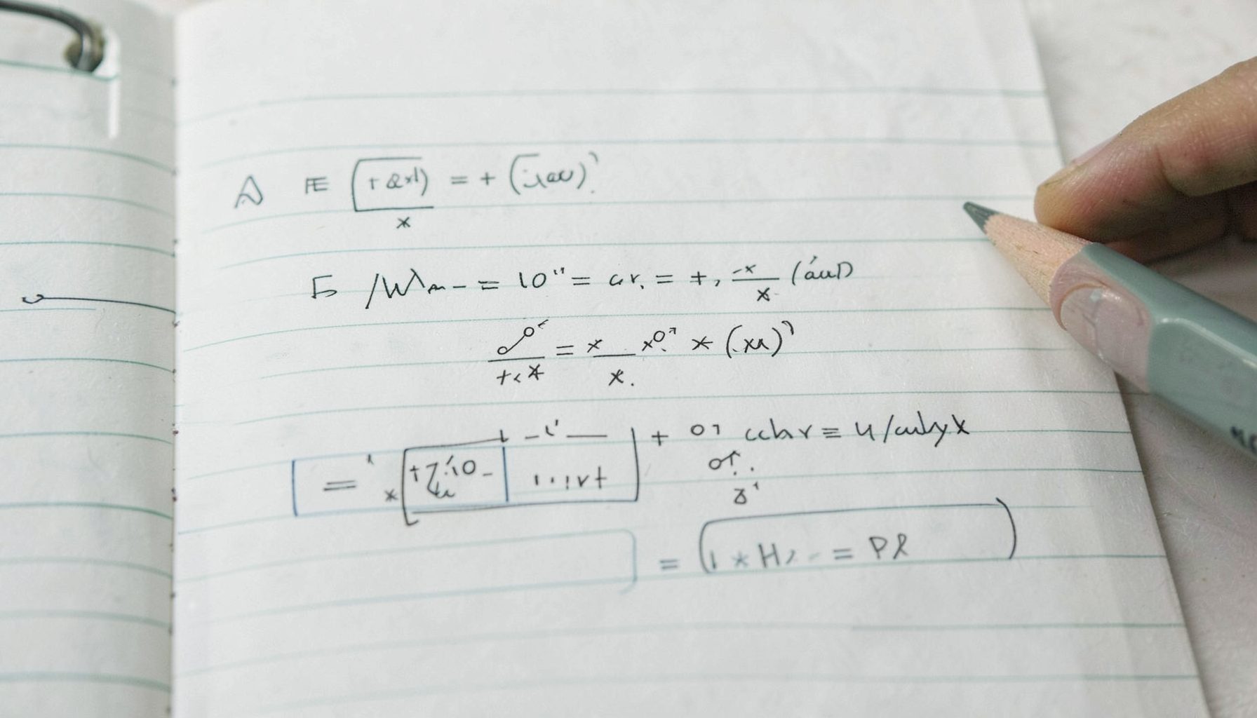 Math equations showing reciprocal relationships on a clean notebook page with pencil, muted greens and grays